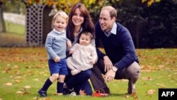 A handout photo obtained in London on Dec. 18, 2015, shows Britain's Prince William (R), Catherine, Duchess of Cambridge (2nd L) and their two children Prince George (L) and Princess Charlotte at Kensington Palace.