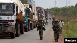 African Union (AU) peacekeepers guard a commercial convoy making its way to the border of Cameroon, near Bangui, March 8, 2014.