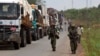 FILE - African Union peacekeepers guard a commercial convoy making its way to the border of Cameroon, near Bangui, Central African Republic, March 8, 2014.