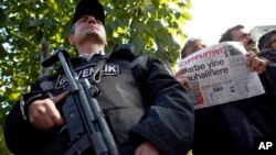 A man holds the latest copy of Cumhuriyet outside its headquarters after Turkish police detained the chief editor and several of the opposition paper's senior staff, in Istanbul, Oct. 31, 2016, amid growing fears over Turkey's widening crackdown on independent media. 