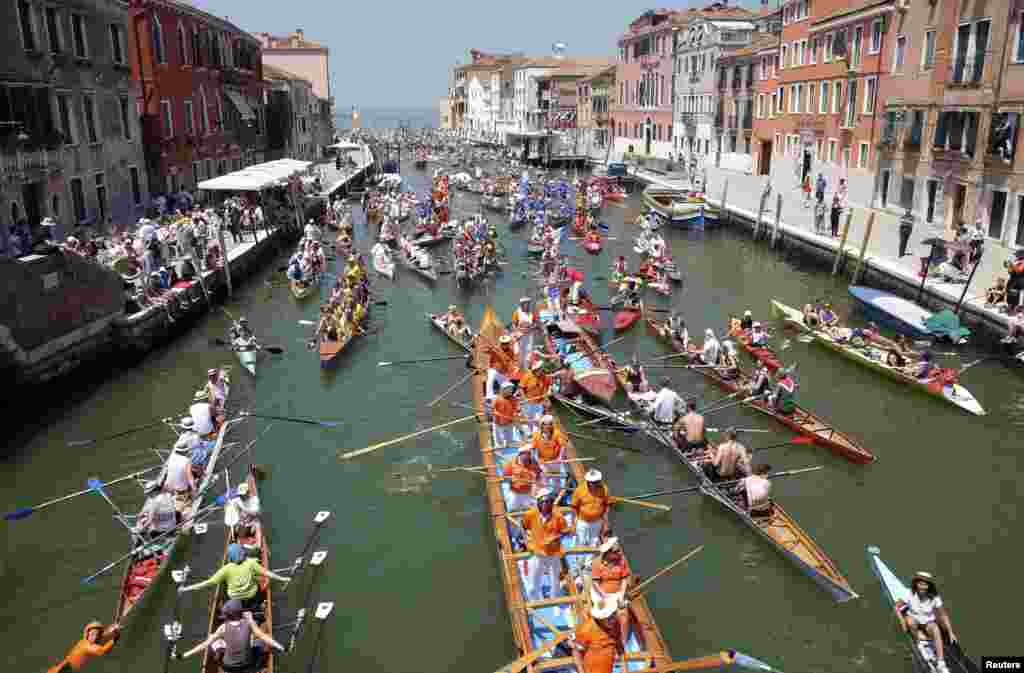 Rowers arrive in the Gran Canal as they take part in the Vogalonga, or Long Row, in the Venice lagoon, Italy.