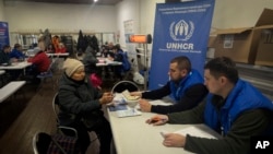 FILE - Employees of the U.N. Refugee Agency register refugees from the Donetsk region, the site of heavy battles with the Russian troops, in Pavlohrad, Dnipropetrovsk region, Ukraine, Dec. 12, 2024. 