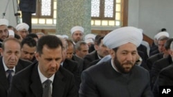 Syrian President Bashar Assad and Grand Mufti Ahmad Badreddin Hassoun (right), attend a religious festival in Damascus. (File Photo)