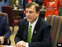FILE - Republican U.S. Rep. John Fleming, speaking with Louisiana election officials in Baton Rouge in July 2016, says the United States "should not be allowing refugees from terrorist regions of the world, without proper vetting."