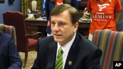 FILE - Republican U.S. Rep. John Fleming, speaking with Louisiana election officials in Baton Rouge in July 2016, says the United States "should not be allowing refugees from terrorist regions of the world, without proper vetting."