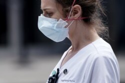 A registered nurse walks out of a hospital during the outbreak of Coronavirus disease (COVID-19), in the Manhattan borough of New York City, New York, U.S., April 1, 2020.