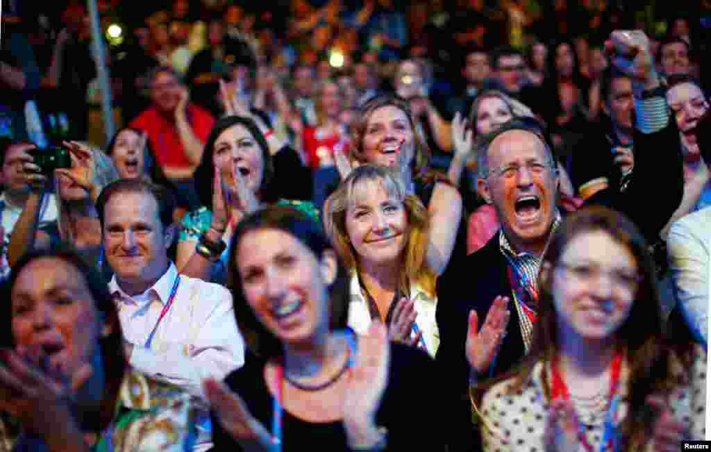 Delegates cheer as an image of Mitt Romney is displayed during the opening session, August 27, 2012. 