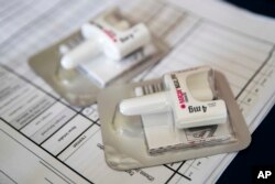 FILE -A Narcan nasal device which delivers naloxone lies on a counter as a health educator gives instructions on how to administer it in the Brooklyn borough of New York, July 3, 2018.