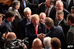 US President Donald Trump is greeted after delivering the State of the Union address at the US Capitol in Washington, DC, on February 4, 2020. (Photo by MANDEL NGAN / AFP)