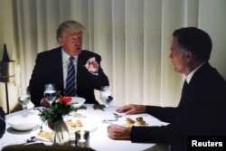 U.S. President-elect Donald Trump sits at a table for dinner with former Massachusetts Governor Mitt Romney, right, at Jean-Georges inside of the Trump International Hotel & Tower in New York, Nov. 29, 2016.