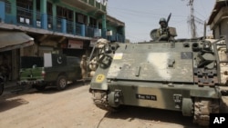 FILE - Pakistani army soldiers patrol in Miran Shah bazaar after driving out militants from the tribal region of North Waziristan along the Afghanistan border, July 9, 2014.