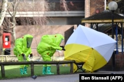 Forensic police officers wearing hazmat suits at the home of Sergei Skripal in Salisbury, England.