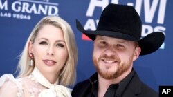 Cody Johnson, right, and Brandi Johnson arrive at the 54th annual Academy of Country Music Awards at the MGM Grand Garden Arena, April 7, 2019, in Las Vegas.
