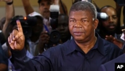 Angola's MPLA main ruling party candidate and defense minister, Joao Lourenco, shows his ink-stained finger after casting his vote in Luanda, Angola, Aug. 23, 2017. Lourenco is the front-runner to succeed President Jose Eduardo dos Santos, who will step down after 38 years in power in an oil-rich country.