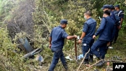 Police personnel surround the remains of an Air Dynasty chopper after it crashed in Nuwakot district, Nepal, on Aug. 7, 2024.