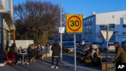 People gather at a restaurant in Reykjavik after Iceland recorded days of zero new cases of COVID-19, April 29, 2020.