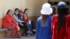 FILE - Garment workers rest inside a factory after their lunch time in Phnom Penh.