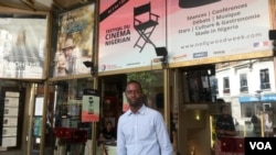 Serge Noukoue in front of the Paris cinema airing the "Nollywood Week" film festival (Lisa Bryant/VOA)