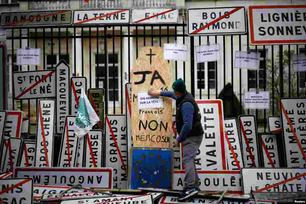 French farmers install city signs in front of the Prefecture to protest against the prospect of a trade agreement between the European Union (EU) and the Latin American countries united within Mercosur, in Angouleme, France.