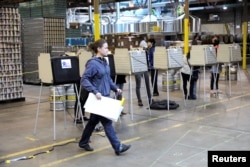 Voters cast their ballots at in the midterm election at the Half Acre brewery in Chicago, Illinois, Nov. 6, 2018.