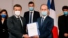 Historian and Commission chief on the France's role in 1994's Rwandan genocide, Vincent Duclert, right, gives a report to French President Emmanuel Macron, at the Elysee Palace, in Paris, Friday, March 26, 2021. The findings of a commission that has…