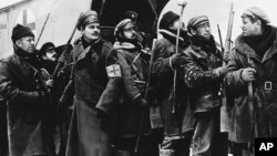 FILE - In a 1965 image provided by MGM, Yuri Zhivago, played by Omar Sharif (2nd from L), is shown arriving with replacement Russian troops in a scene from the film 'Doctor Zhivago.'