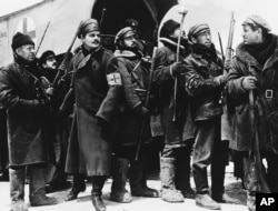 FILE - In this 1965 image provided by MGM, Yuri Zhivago, played by Omar Sharif (2nd from L), is shown arriving with replacement Russian troops in a scene from the film 'Doctor Zhivago.'