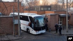 Buses believed to be carrying expelled diplomats leave the U.S. Embassy in Moscow, Russia, April 5, 2018. Russia last week ordered 60 American diplomats to leave the country by Thursday, in retaliation for the United States expelling the same number of Russians.