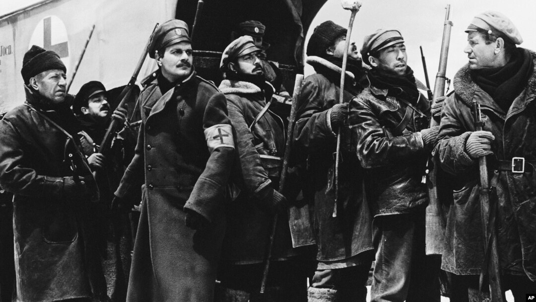 FILE - In a 1965 image provided by MGM, Yuri Zhivago, played by Omar Sharif (2nd from L), is shown arriving with replacement Russian troops in a scene from the film 'Doctor Zhivago.'