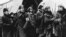 FILE - In this 1`965 image provided by MGM, Yuri Zhivago, played by Omar Sharif (2nd from L), is shown arriving with replacement Russian troops in a scene from the film 'Doctor Zhivago.'