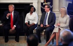 From left, President Donald Trump, joined by Shameka Whaley Green of Toyota, Jim Lentz, CEO of Toyota North America, and his daughter Ivanka Trump speaks during a "Pledge to America's Workers" ceremony in the State Dining Room of the White House