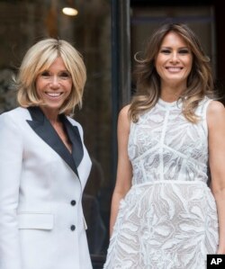 French First lady Brigitte Macron, left, and US First Lady Melania Trump arrive ahead of a NATO spouses dinner at Jubilee Museum in Brussels, Belgium, , July 11, 2018.