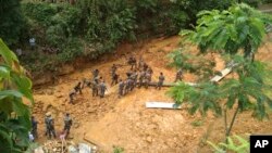 Indian Army soldiers dig at the site of a mudslide as they look for bodies of missing people in Tamenglong district, in the northeastern Indian state of Manipur, July 11, 2018.