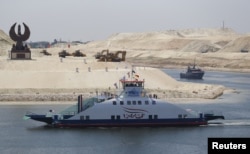 The ship Long Life Egypt crosses a new section of the Suez Canal in Ismailia, Egypt, Aug. 6, 2015. The canal was extended in hopes of powering an economic turnaround.