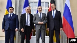 (L-R) Minister of Foreign Affairs of Ukraine Pavlo Klimkin, French Minister of Europe and Foreign Affairs Jean-Yves Le Drian, German Federal Minister for Foreign Affairs Heiko Maas and Russian Minister of Foreign Affairs Sergey Lavrov pose for a picture a