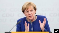 German Chancellor and top candidate of the Christian Democratic Union, CDU, Angela Merkel speaks during an election campaign in Delbrueck, western Germany, Sept. 10, 2017.