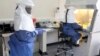 FILE - Doctors work in a laboratory on collected samples of the Ebola virus at the Center for Disease Control in Entebbe.