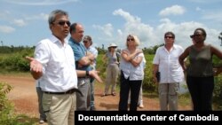 Youk Chhang, Elizabeth Becker and Michael ABRAMOWITZ, USHMM Director and his delegations at a B52 bomb pond near the Chinese airport, Kampong Chhnang province. Oct 24, 2012. Photo by Nhean Socheat.