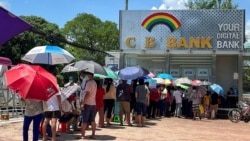 FILE - People line up outside a bank to withdraw cash, in Yangon, Myanmar, May 13, 2021.