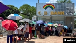 FILE - People line up outside a bank to withdraw cash, in Yangon, Myanmar, May 13, 2021.
