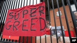 FILE - In this file photo dated Wednesday, April 21, 2021, a protest banner against the proposed Super League is seen outside Liverpool's Anfield Stadium after the collapse of English involvement in the proposed new league, Liverpool, England. 