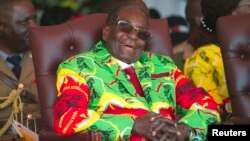 FILE: Zimbabwean President Robert Mugabe smiles during a youth rally in Marondera about 100 kilometers east of Harare, June, 2, 2017. 