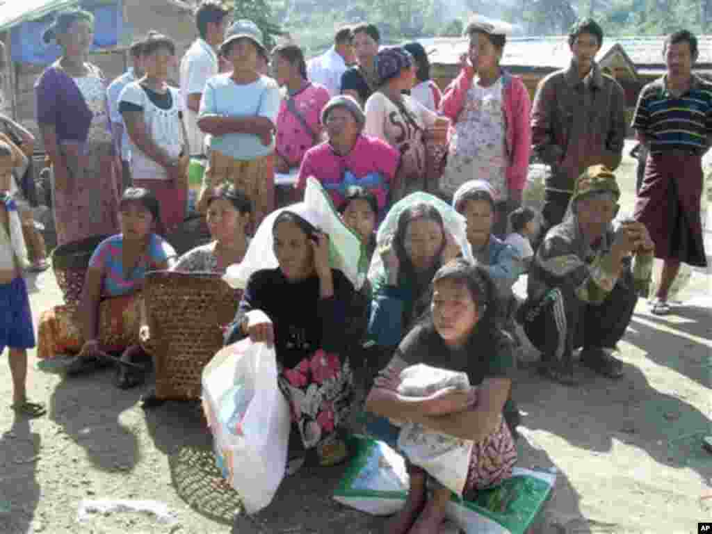 Kachin refugees wait for rations at Je Yang IDP camp, the biggest and closest camp to Laiza, Laiza, northeastern Myanmar, Friday, Jan. 4, 2013. Je Yang is the biggest and closest camp to Laiza where KIA headquarter is located. There are over 7,000 refuge
