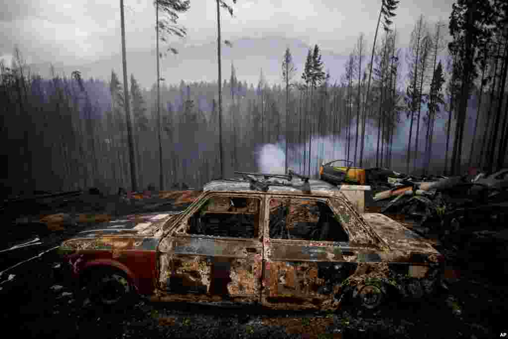 The remains of a burned car sit in a field damaged by a forest fire in Las Golondrinas, in the Chubut southern province of Argentina.