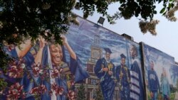 A graduation themed printed mural is seen on the Howard University campus, Tuesday, July 6, 2021, in Washington. (AP Photo/Jacquelyn Martin)