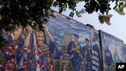 A graduation themed printed mural is seen on the Howard University campus, Tuesday, July 6, 2021, in Washington. (AP Photo/Jacquelyn Martin)