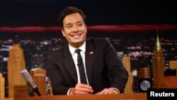 FILE - Tonight Show host Jimmy Fallon is seen during a recording of one of his shows in New York City, Sept. 16, 2017. Fallon, too, has taken on politicians but is seen as softer compared to some of his competitors.