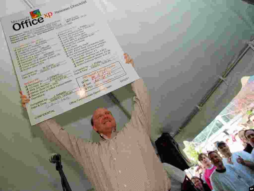 Microsoft CEO Steve Balmer holds a placard checklist for the new Microsoft Office XP at a release party for the software on March 2, 2001, on the Microsoft Campus in Redmond, Washington.
