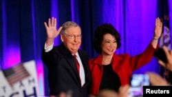 U.S. Senate Minority Leader Mitch McConnell of Kentucky greets supporters at his election night rally in Louisville. He's shown with wife Elaine Chao, former U.S. labor secretary.