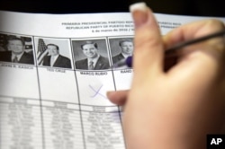 A woman marks her vote for Florida's Senator Marco Rubio during Puerto Rico's Republican primary in San Juan, Puerto Rico, March 6, 2016.